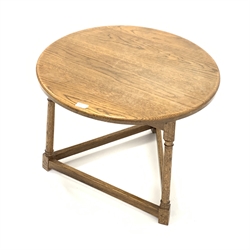  Medium oak circular cricket table, with three turned supports united by stretchers, 66cm x 66cm, H52cm  