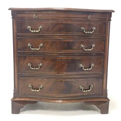 Early to mid 20th century mahogany serpentine front chest, cross banded top over brushing slide, four long graduated drawers and canted fluted corners, raised on bracket supports W71cm, H74cm, D50cm