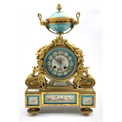 19th century French mantel clock, gilt metal with urn finial over case profusely decorated with a floral composition, enclosing Sevres style panels, dial with Roman chapter ring, eight day movement striking hammer on bell, W26cm