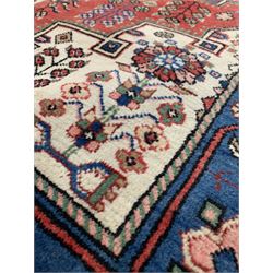 Turkish ground rug, blue lozenge medallion on red field with ivory spandrels and all over stylised floral and geometric design 135cm x 197cm