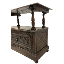 Carolean design oak monks bench or settle, hinged metaphoric table back carved with foliate decoration with central lozenge, turned supports over hinged box seat compartment, the panelled front carved and moulded with Green Man and extending foliage