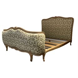 French style 4’ 6” double bedstead, carved beech framed and upholstered in raised foliate pattern fabric, decorated with flower heads