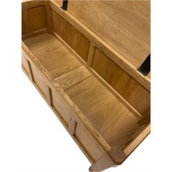 Gott of Pickering - Yorkshire oak style blanket box, the adzed top over four panel front, raised on faceted octagonal supports W107cm, H46cm, D46cm

