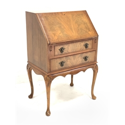 Reproduction mahogany bureau, sloped fall front with fitted interior, two drawers, on shell carved cabriole supports, W64cm, H97cm, D45cm