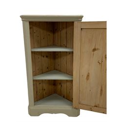 Early 20th century painted pine floor standing corner cupboard, the single panelled door enclosing shelves, raised on shaped skirted base 