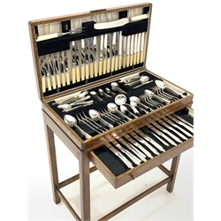 Early 20th century silver plated canteen for twelve covers, in oak case with quarter sawn walnut veneered hinged top and single drawer, raised on square supports, W67cm, H76cm, D38cm