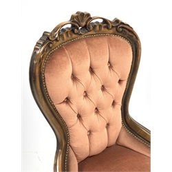 Victorian style beech framed nursing chair, shell and scroll carved cresting rail, upholstered in buttoned pink fabric, cabriole supports, W60cm