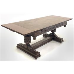 Large oak duo draw leaf dining table, the rectangular top over frieze carved with berries and trailing foliate, raised on baluster turned end supports with similar carving, raised on 'H' base with turned supports L161cm/213cm x 84cm, H78cm