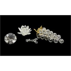 Swarovski Crystal models to include a bunch of Grapes, Lotus candleholder, three rose items tied with a bow and a diamond shaped paperweight, unmarked, three boxed (4)