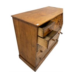 19th century distressed walnut chest, fitted with large deep centre drawer and four small drawers, above three long drawers, raised on a plinth base 
