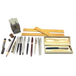Silver propelling pencil, Watermans fountain pen with 14ct gold nib,  Sheaffer and Parker fountain pens, ball point pens etc together with three boxwood rulers and a vintage Dahle 122 table top pencil sharpener