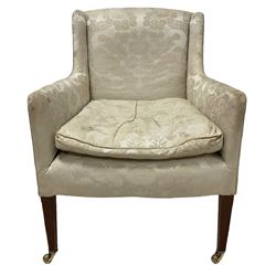 Edwardian mahogany framed armchair, back and sprung seat upholstered in foliate patterned ivory damask fabric, on square tapering supports with brass castors, with floral covering and matching loose cushion
Provenance: From the Estate of the late Dowager Lady St Oswald