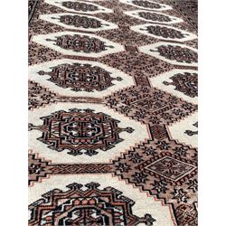 Persian design Bokhara ground rug with repeating gul and lozenge design 195cm x 125cm