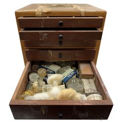 Early 20th century Dentist mahogany field cabinet, having a flush brass carry handle and six graduated drawers, enclosing an arrangement of implements, pharmaceutical bottles and tools, H31cm, D24.5cm, W25.5cm 