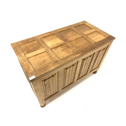 'Eagleman' oak blanket box, with eight panelled hinged lid over four panelled front carved with linen folds, raised on turned octagonal supports, W93cm, H61cm, D47cm