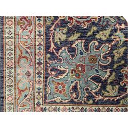 Persian indigo ground carpet, the field decorated with stylised plant motifs and trailing scrolling branches, similar design border surrounded by multiple guards with scrolling foliage and floral repeating patterns