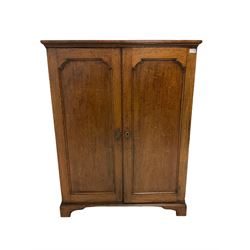 Georgian oak cupboard, the projecting cornice over two doors, opening to reveal four adjustable shelves, raised on bracket 