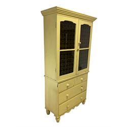 Yellow painted kitchen cabinet, the projecting cornice and two glazed doors, opening to reveal four fixed shelves over two long and two short drawers, raised on tuned supports 