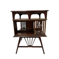 Edwardian mahogany revolving bookcase, squared top with moulded edge over two tiers, the uprights with pierced decoration, raised on splayed square supports with turned and fanned upright stretchers 