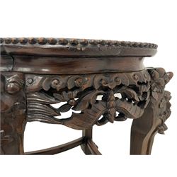 Late 19th to early 20th century carved hardwood jardinière or urn stand, shaped rose marble top enclosed by bead carved surround, the frieze rails carved and pierced with foliage decoration, on dragon mask carved cabriole supports with ball and claw feet united by curved stretchers