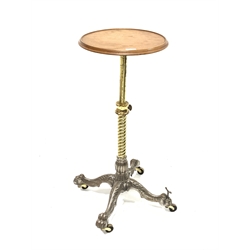 Early to mid 20th century rise and fall table, telescopic circular dished walnut top with a moulded edge, spiral column on four out splayed supports terminating in paw feet, four castors, one castor adjustable, possibly a shop fitting, top diameter - 36cm, max height - 89cm, min height - 65cm
