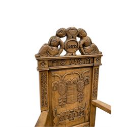 Pair 17th century style oak armchairs, the cresting rail mounted by two lounging figures, panelled back carved with stylised plant motifs and flower heads, moulded seat with four turned pillar arm supports, turned and carved supports joined by plain stretchers 