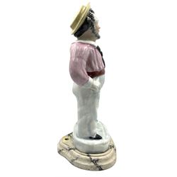 Staffordshire pottery standing figure of a sailor smoking a pipe, on a later wooden base H37cm