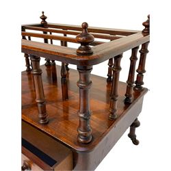 Victorian walnut and amboyna Canterbury or magazine rack, three divisions on turned balustrade supports, fitted with single drawer, on turned feet with brass and ceramic castors
