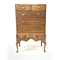Mid 19th century oak chest on stand, the top section fitted with two short and three long graduated drawers, three drawers and shaped apron to base, raised on cabriole supports 