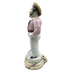 Staffordshire pottery standing figure of a sailor smoking a pipe, on a later wooden base H37cm