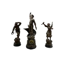 An imposing group of patinated spelter figures on round ebonised bases titled “Cod Fishing” “Distress” and “Rescue” the base of the central figure fitted with a continental (German?) spring driven movement striking the hours on a bell, two-part dial with a gilt centre and ivorine chapter, Arabic numerals, minute markers and steel spade hands within a glazed brass bezel, with pendulum.
Height of figures 77cm and 56cm. 
Noble and striking groups of figures such as these were very popular for a short period in the early 20th century up until the 1st World War, invariably depicting the hazardous life of mariners, costal fishermen or other workers involved in hazardous occupations. 
