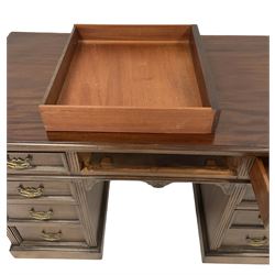 Hardwood pedestal desk, three frieze drawers over six graduated drawers, raised on plinth base 