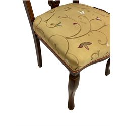 Set four Edwardian walnut dining chairs, the pierced splat back inlaid with flowerheads and scrolling foliate design, sprung seat upholstered in floral champagne fabric, raised on cabriole supports