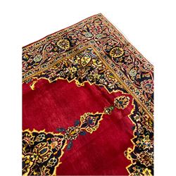 Persian Kashan rug, red, blue and gold ground, floral pole medallion on plain field, the guarded border decorated with scrolling foliate and stylised flower heads 