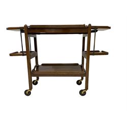Early 20th century Art Deco oak two-tier tea trolley, with removable trays and extendable cake stands on each end, supported by fluted uprights on castors