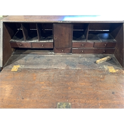 Early 19th century oak bureau, fall front revealing fitted interior over four long graduated drawers, raised on bracket supports 