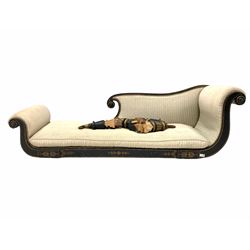 Regency ebonised chaise longue of scrolling form, the frame with gilt painted details, upholstered in striped fabric with squab cushion, raised on turned supports with castors W190cm
