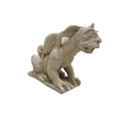 Composite stone grotesque or gargoyle statue, in a crouched pose on clawed feet with single horn and wings 