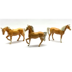 Three Beswick horses in palomino gloss comprising Arab type No. 1261, first version, Stocky Jogging Mare  no. 855 third version and an Arab horse No.1265