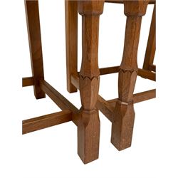 Wrenman - set four oak dining chairs, the cresting rail carved with wren signature over triple fielded panel back, leather upholstered seats with studwork, on carved octagonal front supports joined by plain stretchers, by Robert (Bob) Hunter of Thirlby, Thirsk