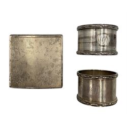 Engine turned square silver powder compact with interior mirror London1946 and two silver serviette rings