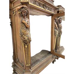 Pair late 19th century walnut and parcel gilt side cabinets, stepped and moulded sarcophagus top carved with bellflower arcade and acanthus leaf, the frieze fitted with single drawer carved with cartouche escutcheon and trailing foliage, bevel glazed door enclosing lined and mirror interior, flanked by carved male and female figure pilasters, stepped and moulded plinth with fluting, lobe carved turned feet