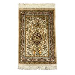 Fine silk Persian Hereke rug, the mihrab enclosing flower heads and interlacing tree branches, central floral medallions, multi-band guarded border decorated with stylised plant motifs and geometric designs, with signature panel 