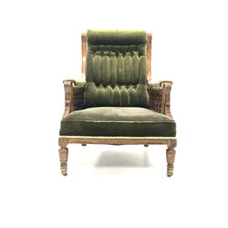 Quality late 19th century figured walnut armchair, upholstered in green buttoned velvet, the arms with floral  carved pierced fretwork, raised on turned supports and castors W66cm
