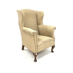  Georgian design wing back armchair, upholstered in cream fabric, raised on walnut cabriole front supports, W79cm  