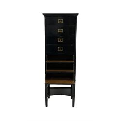 Ebonised sheet music cabinet, the projecting top over seven fall front drawers with Wellington style lock and one under-tier raised on squared tapering supports 