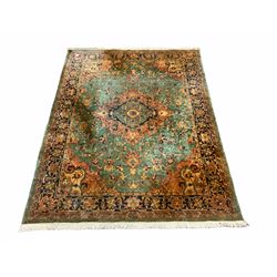 Persian style green ground rug carpet, large central medallion surround by geometric design and stylised flower heads, four band border 362cm x 275cm