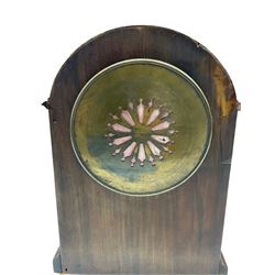An Edwardian mahogany mantle clock with a break arch top, inlaid satinwood stringing and banding, case on a moulded plinth raised on four bun feet, with a French eight-day movement striking the hours and half hours on a coiled gong,  square movement plates stamped “B.T.G Medaille d’or”, six-inch enamel dial with upright Arabic numerals and minute markers, quarter hours in red Arabic’s, with steel moon hands, cast brass dial bezel with a convex glass, brass case door with pierced sound fret.  With pendulum and key.  