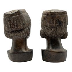 Pair of African carved iron wood male heads each wearing a Kofia cap H18cm