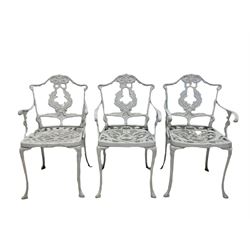 Victorian design white painted cast alloy circular garden table, with a pair of white chairs, together with a close set of three white chairs